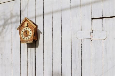 Old clock on a wooden light wall. vintage clock. cuckoo clock | Premium ...