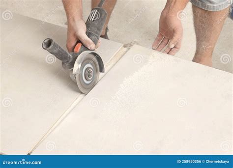 Worker Cutting Tiles with Circular Saw Indoors, Closeup Stock Photo ...