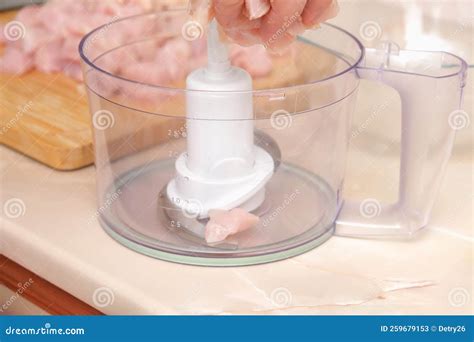 A Man Puts Pieces of Defrosted Raw Chicken Fillet into the Bowl of a ...