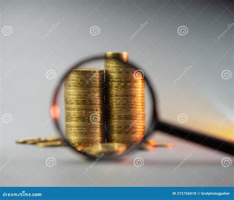 Two Stacks of Coins Under a Magnifying Glass Stock Photo - Image of ...