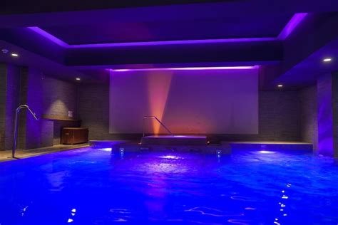 Luxury indoor swimming pool with vibrant blue lighting in zermatt hotel ...