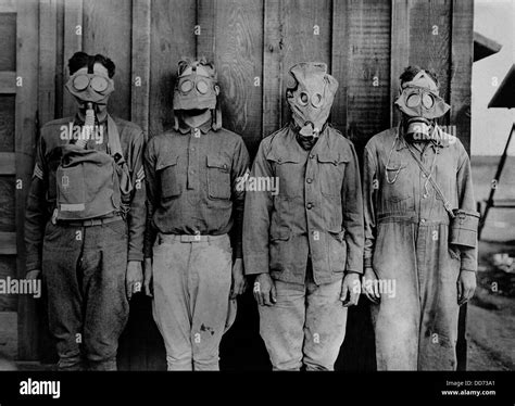 Soldiers wearing WW1 gas masks. L-R: American, British. French, German ...