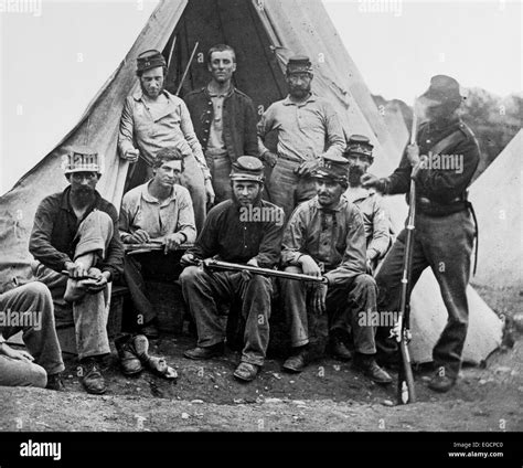 1860s GROUP OF NINE UNION SOLDIERS SEATED IN FRONT OF TENT HOLDING ...