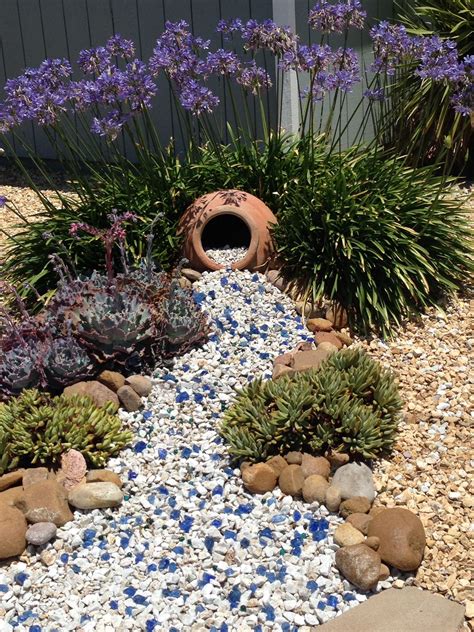 Three years after first posted, plants have grown and blue rock added ...