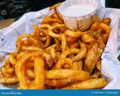 A Large Basket of Curly Fries and Ranch Dressing Stock Image - Image of ...
