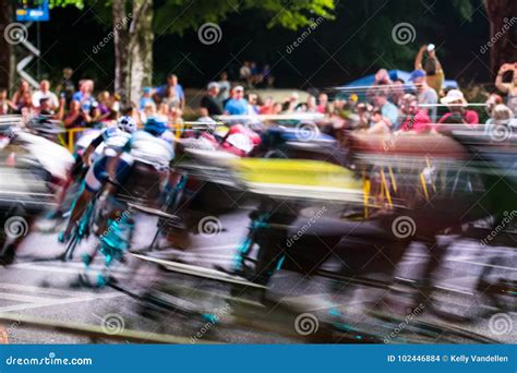 Cyclists Rush Around Corner at Twilight Editorial Stock Image - Image ...