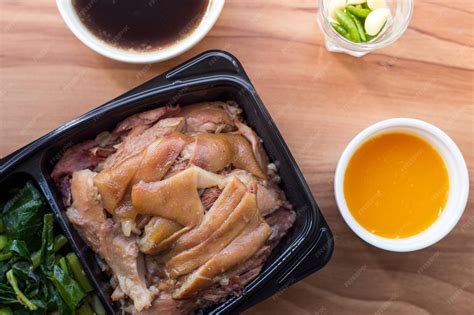 Premium Photo | Pork leg stew in takeaway box with vegetables and ...