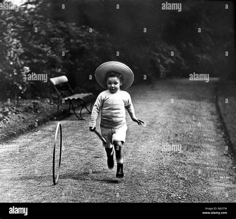 Boy playing with hoop and stick Stock Photo - Alamy