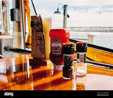 The condiment ketchup, salt and pepper with a drink menu on a ...