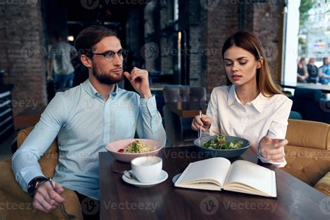 business men and women sit at the table with the phone chatting ...