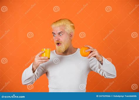 Orange Juice. Man with Orange Fruit on Orange Background. Close Up ...