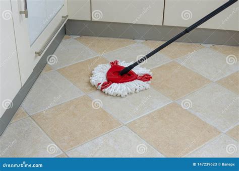 Mop on kitchen floor stock image. Image of tidiness - 147239623