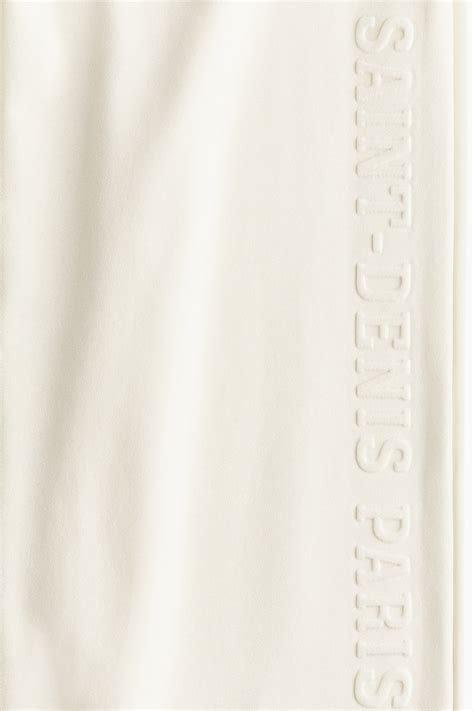 Wide motif-detail joggers - Light beige/Saint-Denis - Ladies | H&M IN