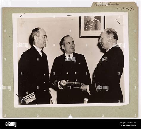 Lt. Commander Francis C. Pollard of the U.S. Coast Guard receives a ...