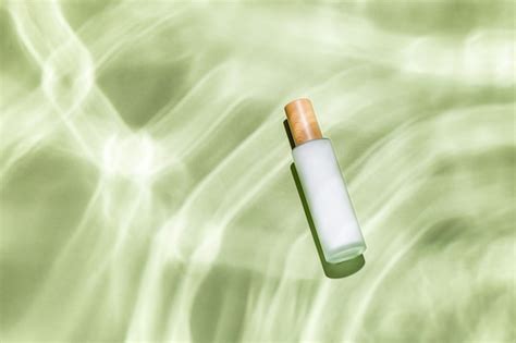Top view of a skin care bottle on a green textured surface | Free Photo