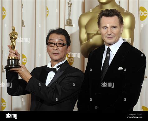 Director Yojiro Takita holds the Oscar for best foreign language film ...