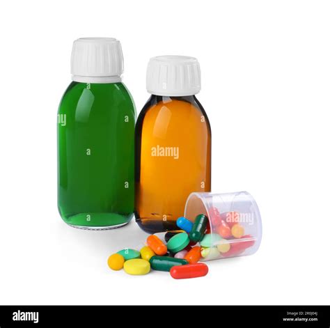 Bottles of syrups, measuring cup with pills on white background. Cough ...