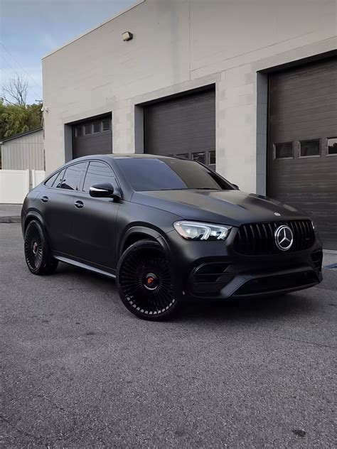 Black Mercedes SUV parked in front of a garage