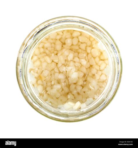 Top view of an opened jar of minced garlic on a white background Stock ...