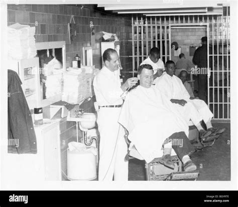 Inmate giving a member of the staff a haircut. Metal scissors and ...