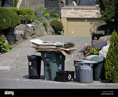 Trash cans in residential home driveway awaiting garbage pickup Seattle ...