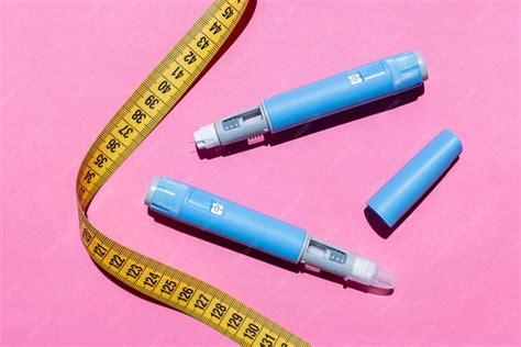 Ozempic pens with measuring tape flat lay pink background suggests ...