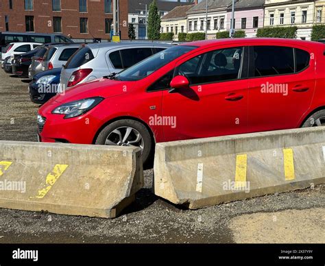 Cars in the parking lot behind concrete barricades Stock Photo - Alamy