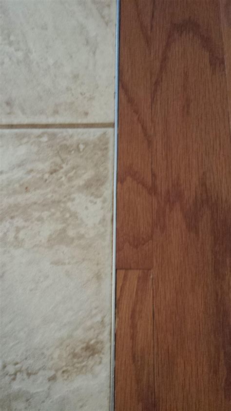Seamless and Stylish Transition from Laminate Wood Floor to Tile