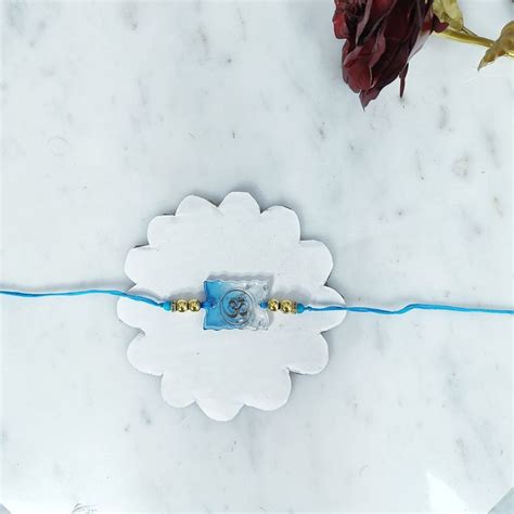 Send Sacred Blessing Resin Om Rakhi Online