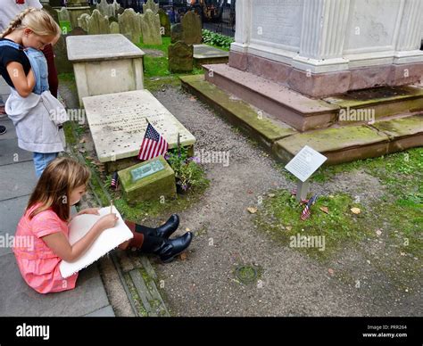 Young girl making notes as she sits in front of the tombs of Alexander ...