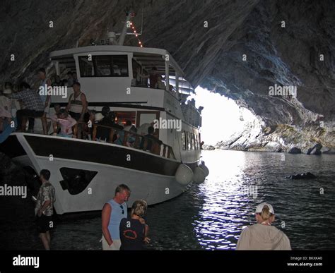 A boat in the Papanikolis Cave, Meganissi island, Greece. The cave got ...