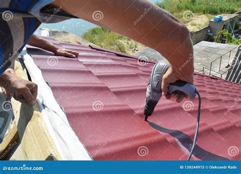 Roofing Contractors Installing Metal Roof Tile for Roof Repair. Roofing ...