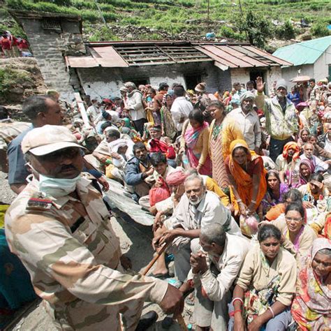 Stranded pilgrims wait for IAF helicopter during the rescue operations ...