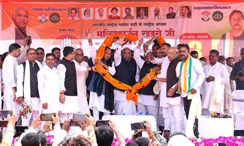 Congress National President Mallikarjun Kharge is garlanded by party ...