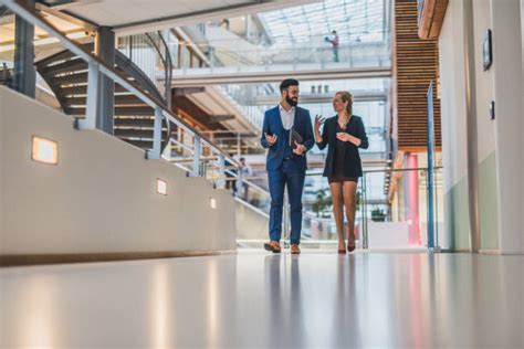 Two Business People Walking Side by Side 的图像结果