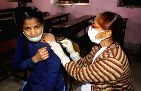 A student receives a dose of Covid-19 vaccine