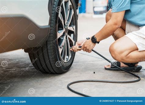 Man Driver Hand Inflating Tires of Vehicle, Removing Tire Valve ...