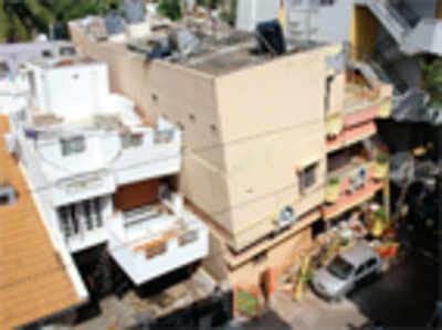 Building leans on next house, razed