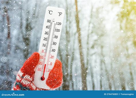 White Celsius and Fahrenheit Scale Thermometer in Hand. Ambient ...