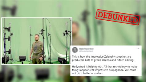 Zelensky wearing a green shirt speaks in a dimly-lit room. An out-of-focus Christmas tree is in the