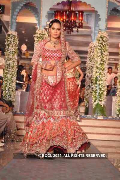 A model walks the ramp to showcase a creation during a bridal show ...