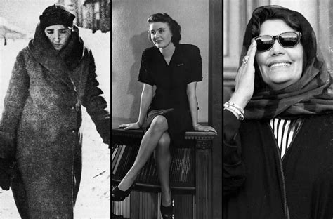 Black-and-white photo of Saddam Hussein, in a suit, with a group of women students