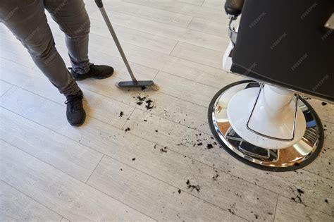 Premium Photo | Crop person cleaning floor after haircut at barbershop