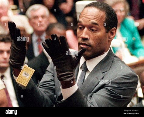 FILE - In this June 21, 1995 file photo, O.J. Simpson holds up his ...