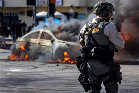 In pictures: Riot police, anti-ICE protesters clash in Los Angeles ...