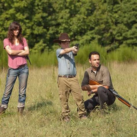 Four figures in action, including a man with a top knot crouching and shooting, a figure in a green