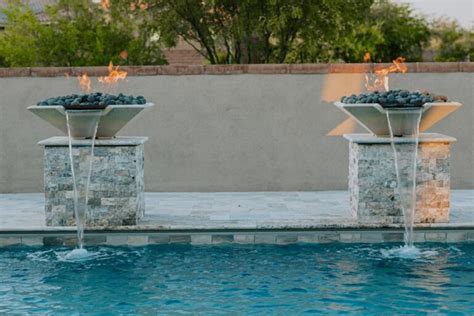 https://poolsbydesignaz.com/wp-content/uploads/2020/12/twin-fire-pillars-pool-fire-features-tucson-1-768x512.jpg