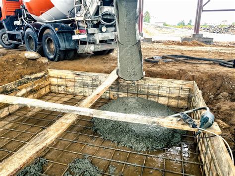 Premium Photo | Pouring the foundation with concrete at the ...