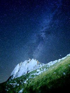 Download wallpaper 240x320 mountain, rock, slope, milky way, grass old ...