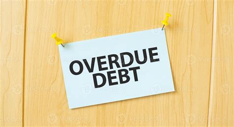 overdue debt sign written on sticky note pinned on wooden wall 22858817 ...